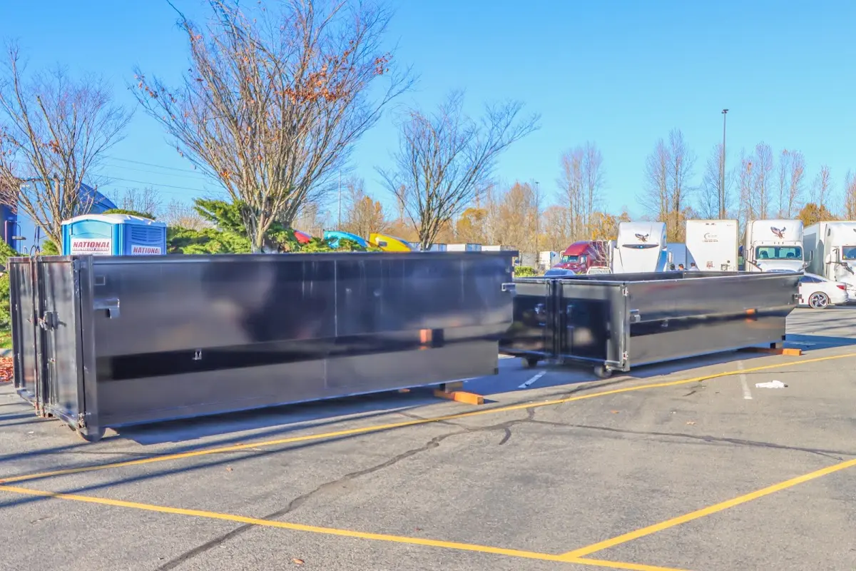 Professional dumpster rental service with roll-off container on residential driveway in Independence